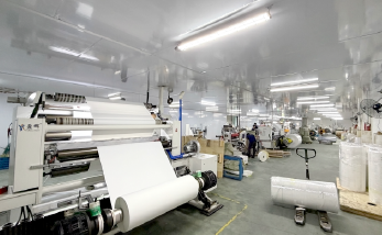 Self-adhesive labelstock converting workshop with multiple roll processing machines and jumbo rolls